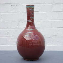 A Chinese oxblood-glazed bottle vase with overglaze design of a dragon and a carp, 19th C.