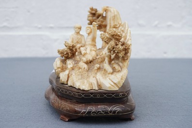 A Chinese carved ivory group of a two shepherds with their flock, 1st half 20th C.