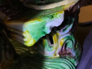 A Chinese verte biscuit group of Guanyin on a lotus throne, 18th C.