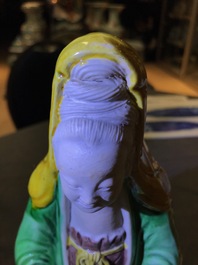 A Chinese verte biscuit group of Guanyin on a lotus throne, 18th C.