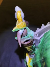 A Chinese verte biscuit group of Guanyin on a lotus throne, 18th C.