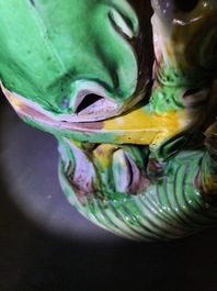 A Chinese verte biscuit group of Guanyin on a lotus throne, 18th C.