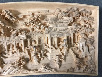 A Chinese carved ivory panel with figures in a landscape on inlaid wooden stand, first half 20th C.