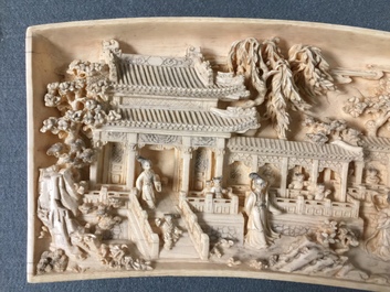 A Chinese carved ivory panel with figures in a landscape on inlaid wooden stand, first half 20th C.