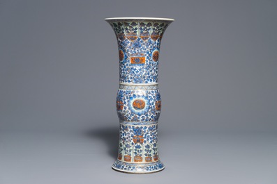 A clobbered Chinese blue and white 'gu' beaker vase, Kangxi