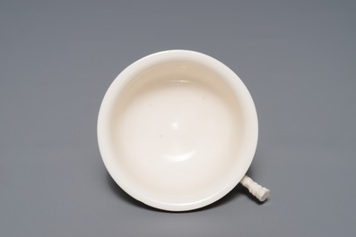 A Chinese Dehua blanc de Chine cup with applied design, seal mark, Kangxi