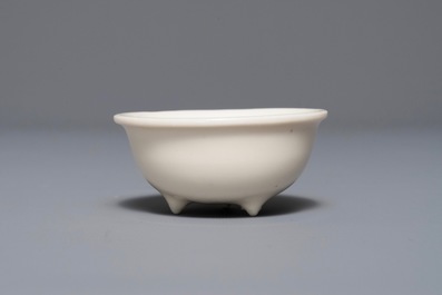 A Chinese Dehua blanc de Chine tripod cup, Kangxi