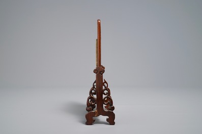 A small Chinese jade plaque mounted in a carved wood table screen, 19/20th C.