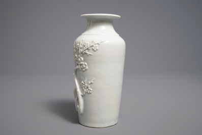 A Chinese Dehua blanc de Chine rouleau vase with incised and applied design, Kangxi