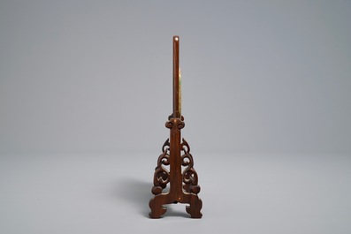 A small Chinese jade plaque mounted in a carved wood table screen, 19/20th C.