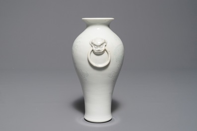A Chinese Dehua blanc de Chine meiping vase with anhua design of Buddhist lions, Kangxi