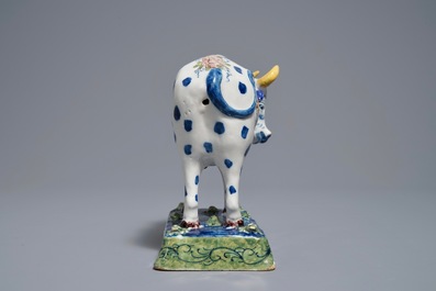 A polychrome Dutch Delft cow on a base with frogs, 18th C.