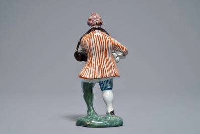 A polychrome Dutch Delft model of a hurdy-gurdy player, 18th C.
