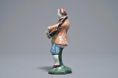 A polychrome Dutch Delft model of a hurdy-gurdy player, 18th C.