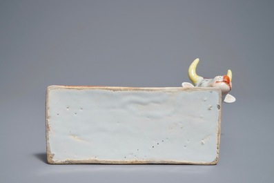 A polychrome Dutch Delft petit feu cow on base, 18th C.