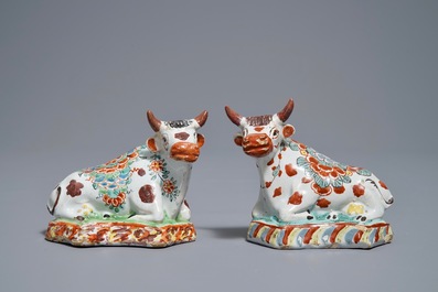 A pair of polychrome Dutch Delft petit feu cows on bases, 18th C.