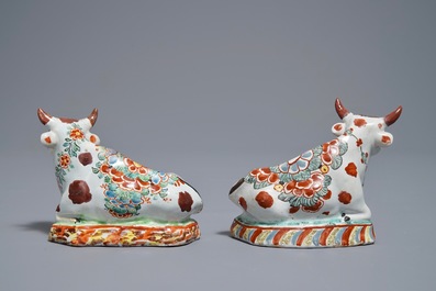 A pair of polychrome Dutch Delft petit feu cows on bases, 18th C.