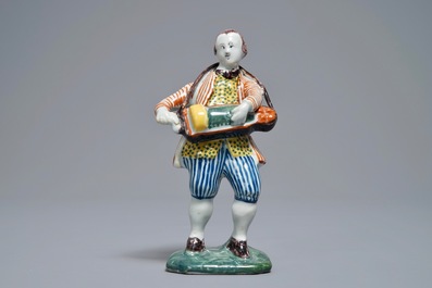 A polychrome Dutch Delft model of a hurdy-gurdy player, 18th C.