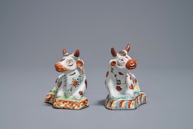 A pair of polychrome Dutch Delft petit feu cows on bases, 18th C.