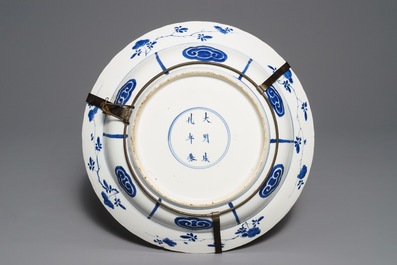 Un plat en porcelaine de Chine bleu et blanc &agrave; d&eacute;cor d'une bataille, marque de Chenghua, Kangxi