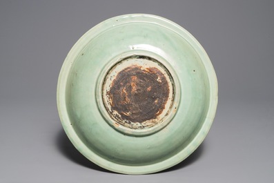 Een Chinese Longquan celadon schotel met onderglazuur pioenrozendecor, Ming