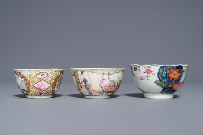 A Chinese famille rose 'Mandarin' cup and saucer and two cups, Yongzheng/Qianlong