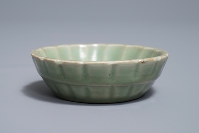A small moulded Longquan celadon 'chrysanthemum' bowl, Song or Ming