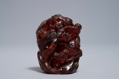 A Chinese carved amber group of a tiger below a pine tree and a dragon, 19/20th C.