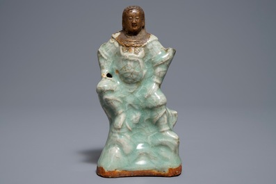 A Chinese Longquan celadon and biscuit figure of Zhenwu, Ming