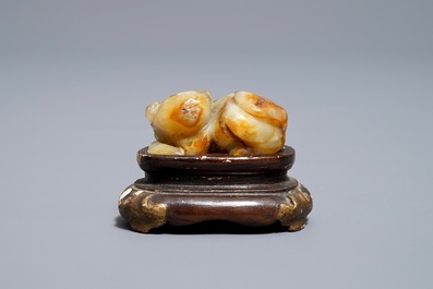 A Chinese celadon and russet jade carving of a tiger, Ming