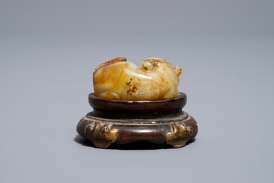 A Chinese celadon and russet jade carving of a tiger, Ming
