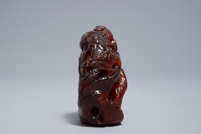 A Chinese carved amber group of a tiger below a pine tree and a dragon, 19/20th C.