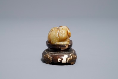 A Chinese celadon and russet jade carving of a tiger, Ming