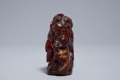 A Chinese carved amber group of a tiger below a pine tree and a dragon, 19/20th C.