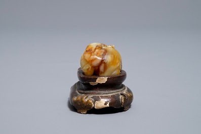 A Chinese celadon and russet jade carving of a tiger, Ming