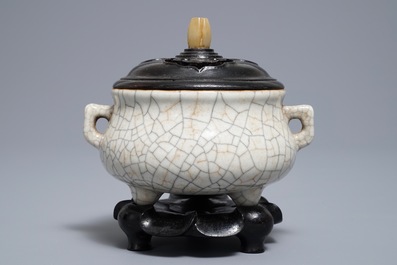 A Chinese ge-type crackle-glazed tripod censer and cover on stand, 19/20th