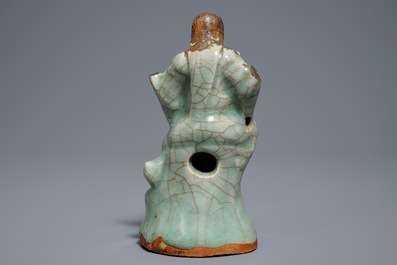 Een Chinese Longquan celadon en biscuit figuur van Zhenwu, Ming