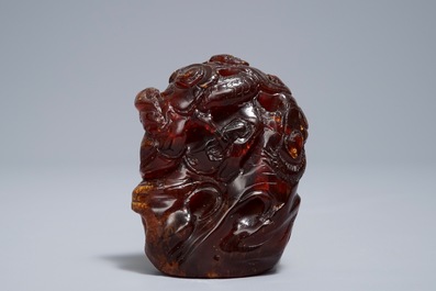 A Chinese carved amber group of a tiger below a pine tree and a dragon, 19/20th C.