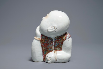 A Chinese famille rose headrest in the shape of a boy, Republic, early 20th C.