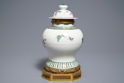 A Chinese famille verte gilt bronze-mounted vase and cover, 19th C.