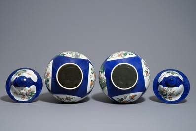 A pair of Chinese famille verte blue ground vases and covers, 19th C.