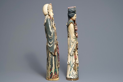 A pair of tall Chinese polychrome ivory figures on wooden bases, 19th C.