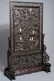 A large Chinese carved zitan wood panel with jade and turquoise, set in a hongmu wood frame and stand, Qianlong