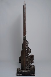 A large Chinese carved zitan wood panel with jade and turquoise, set in a hongmu wood frame and stand, Qianlong