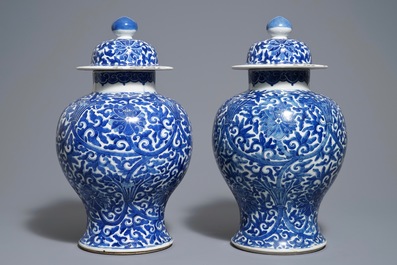 A pair of Chinese blue and white 'lotus scroll' vases and covers, 19th C.