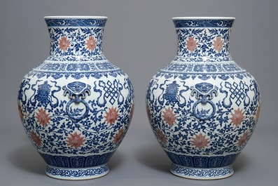 A pair of Chinese blue, white and iron red hu vases with taoist symbols, Qianlong mark, 20th C.