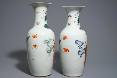A pair of Chinese famille rose vases with figures in a garden, 19th C.