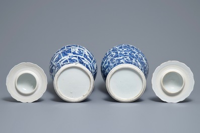 A pair of Chinese blue and white vases and covers with landscape panels, Kangxi