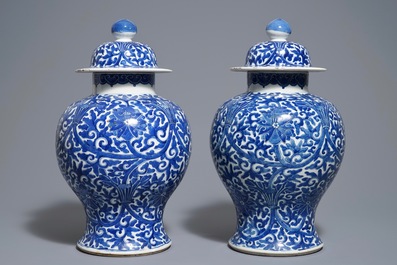 A pair of Chinese blue and white 'lotus scroll' vases and covers, 19th C.