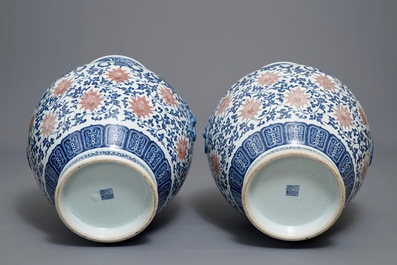 A pair of Chinese blue, white and iron red hu vases with taoist symbols, Qianlong mark, 20th C.